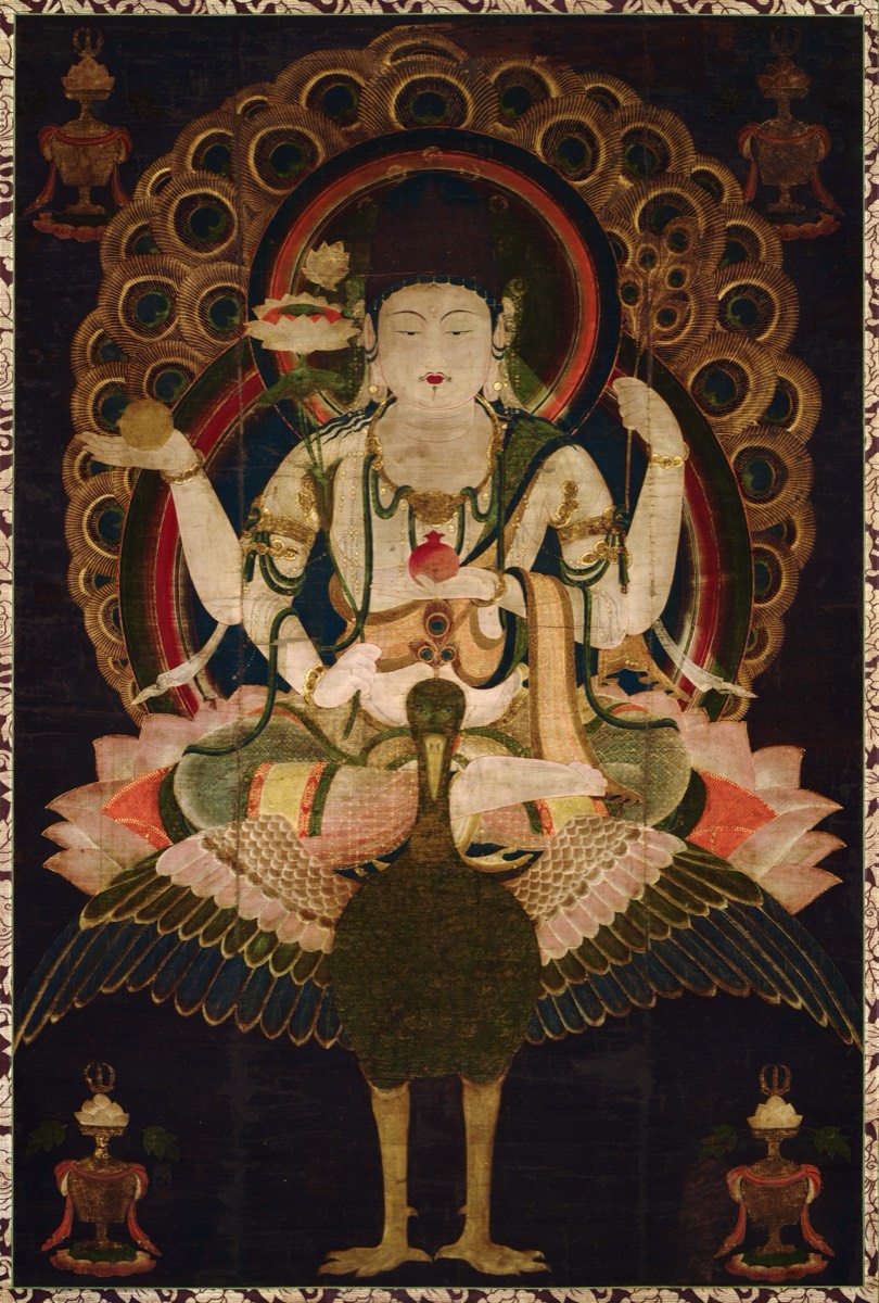 Mahamayuri seated on a peacock with multiple arms and a feathered aureole — TK0654