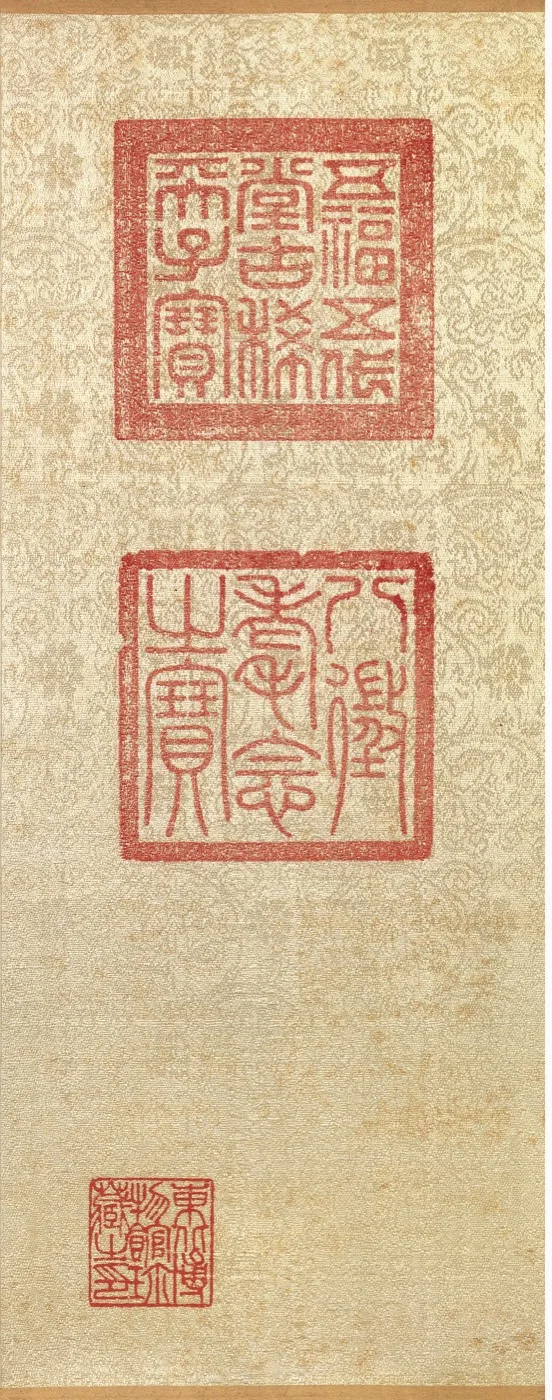 Buddhist painting seals: three red collector marks on a patterned scroll mounting — TK0779