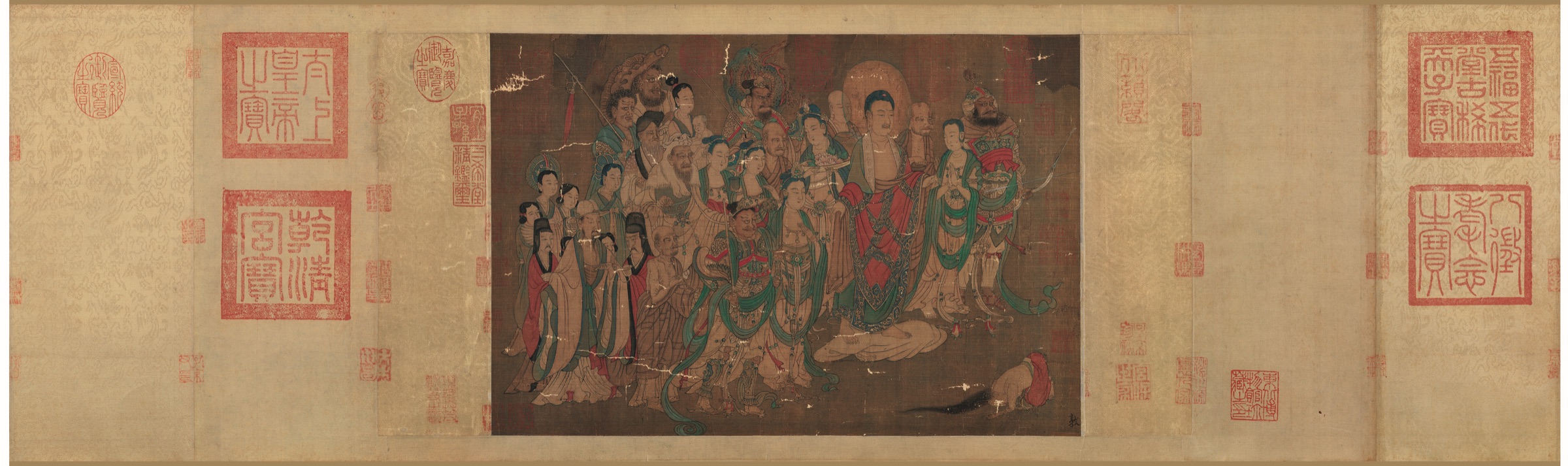 Horizontal Buddhist handscroll with a standing Buddha, clustered attendants, kneeling figure, and red collector seals — TK0210