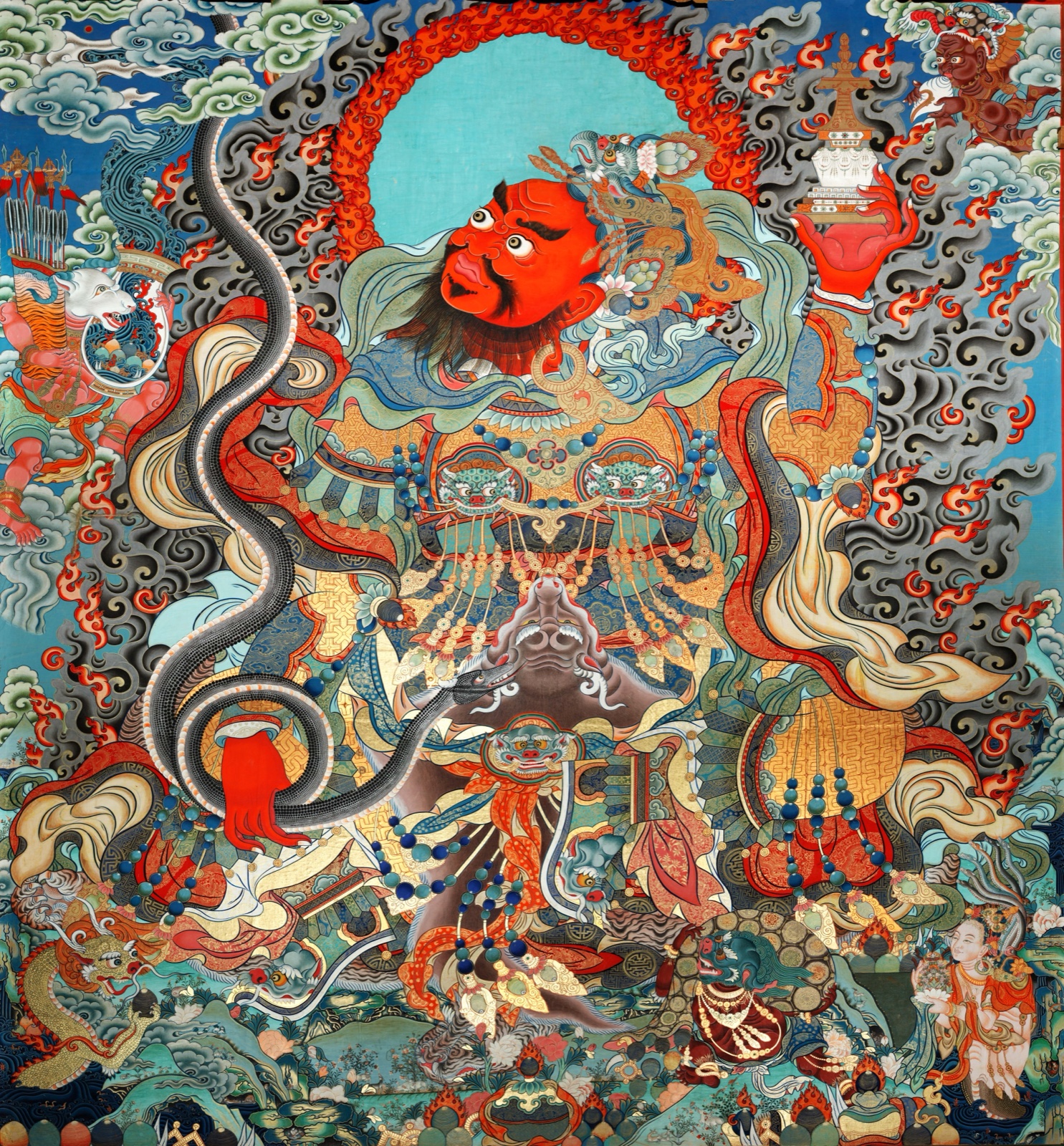 Red-faced wrathful Buddhist figure holding a stupa, framed by looping serpents, flames, smoke, weapons, animal-headed attendants, and offerings — TK1235