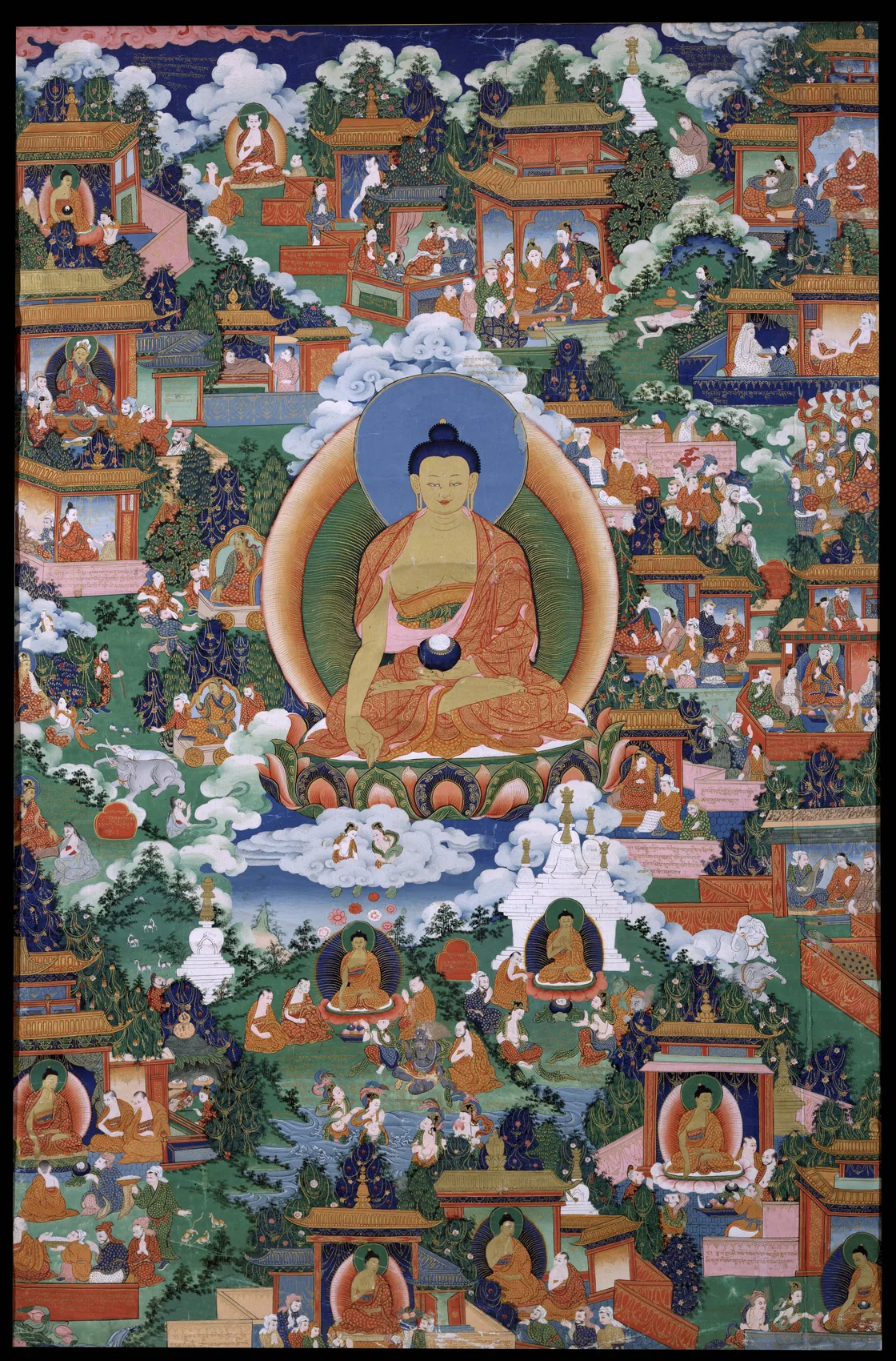 Large seated Buddha-like main icon surrounded by architecture, inscriptions, teachers, animals, and embedded narrative scenes — TK0580