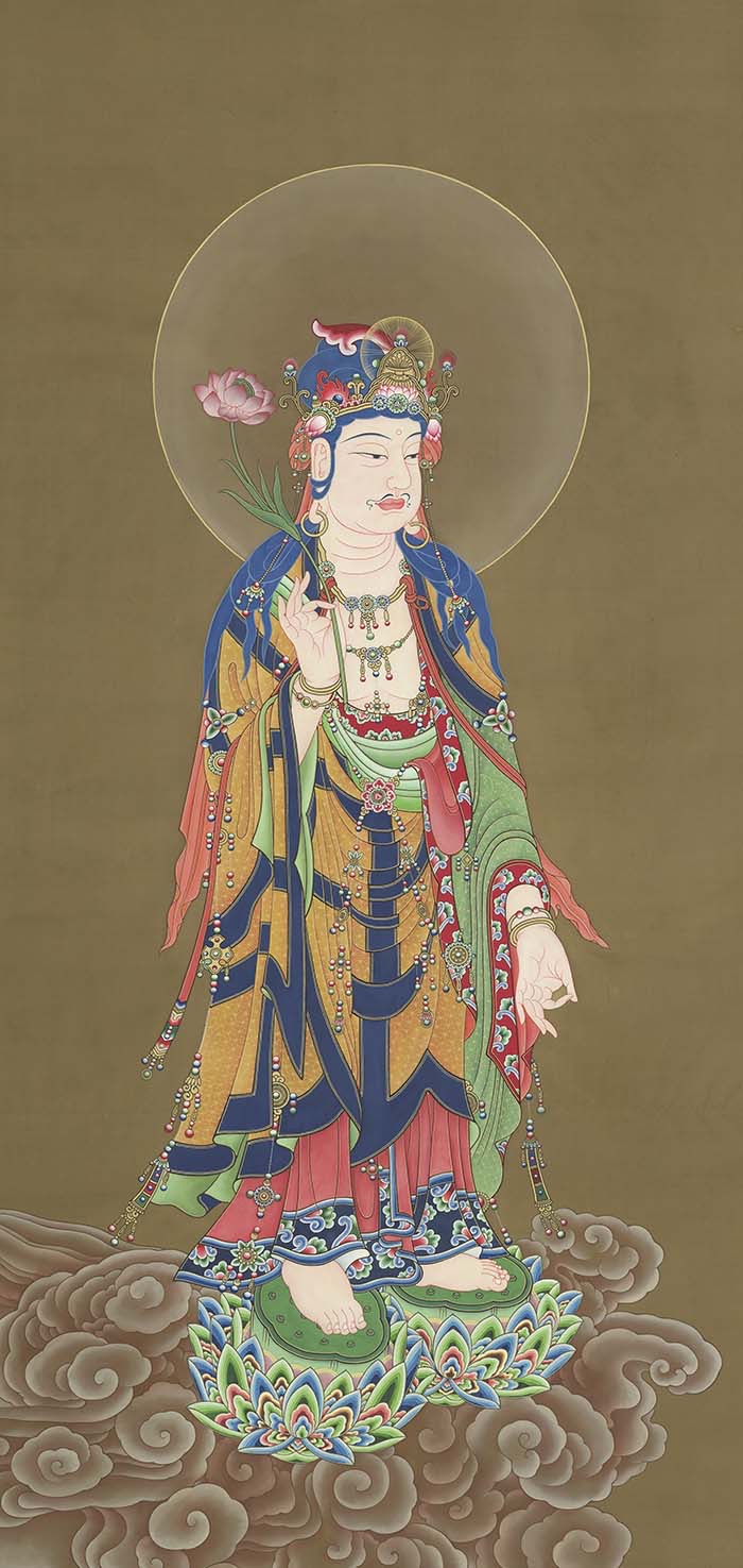 TK1105, a haloed standing Buddhist figure holding a long flower stem that rises diagonally toward a pink blossom beside the head, above a lotus-and-cloud base.
