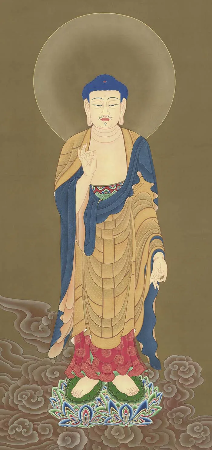 One standing Buddha-like figure with a circular halo, raised and lowered hands, gold-and-blue robes, and a multicolored lotus base amid clouds — TK1109.